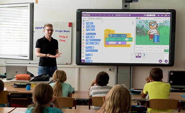 Children engaged in learning coding on PictoBlox in classroom