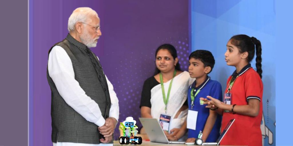 Kendriya Vidyalaya students with their teacher presenting a Quarky robot kit to PM Narendra Modi at STEMpedia's Skill Expo