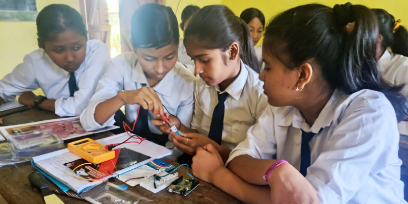 School girls engaging with AI and robot kits in a PM Shri Tinkering Lab, enhancing STEM learning