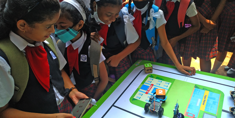 Young girls engage in coding robots with PictoBlox during the STEMpedia workshop at SCI-FFI Goa