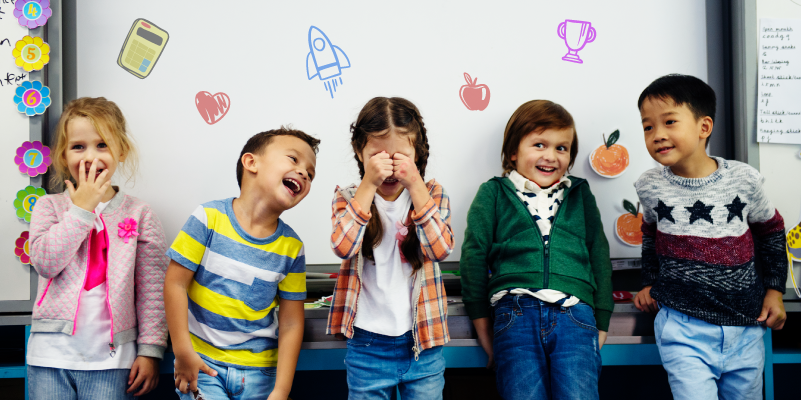 A group of joyful children in a classroom illustrating the impact of technology in education on fostering creativity