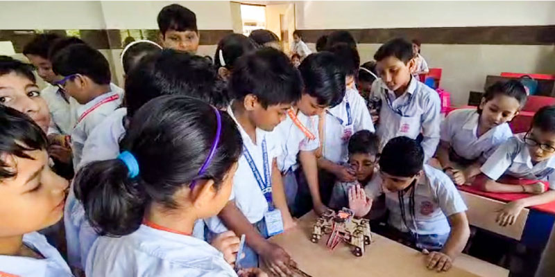 A group of students interacting with Quadruped robot