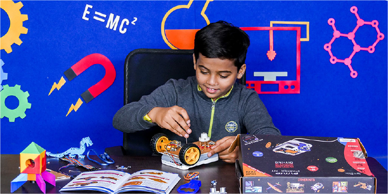 Young boy DIYing with Evive Starter Kit to build a hands-on robotics and AI project